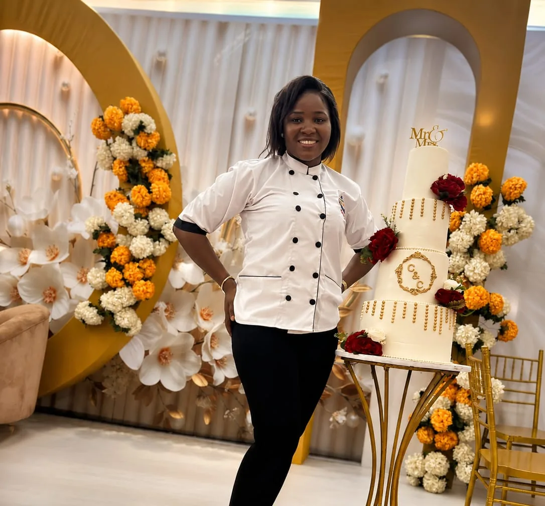 Chinny Cakes & More baker standing beside a wedding cake