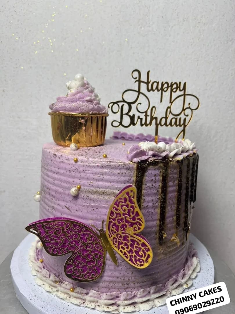 Purple birthday cake with chocolate drip, gold and purple butterfly decorations