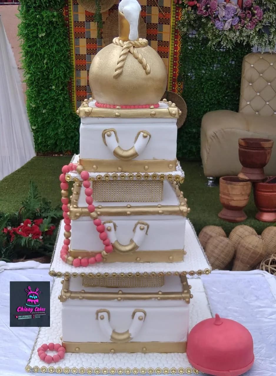 White and gold multi-tier traditional cake with pink bead details